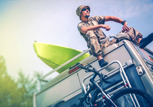 Man sitting on roof of motorhome